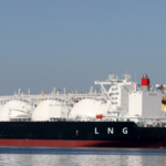 LNG cargo ship docked at an industrial port terminal