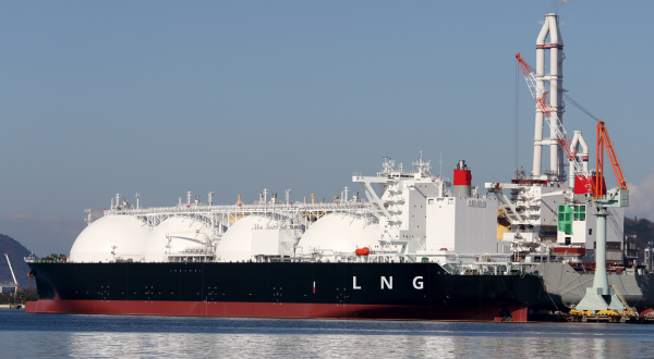 LNG cargo ship docked at an industrial port terminal